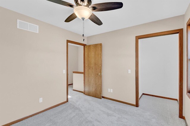 unfurnished bedroom featuring ceiling fan and light colored carpet