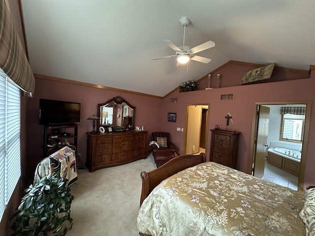 carpeted bedroom featuring multiple windows, connected bathroom, ceiling fan, and lofted ceiling