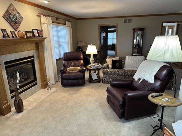 carpeted living room with ornamental molding and a tiled fireplace