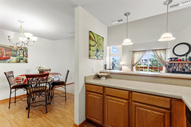 kitchen with pendant lighting, a chandelier, and light hardwood / wood-style flooring