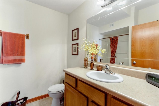 bathroom featuring curtained shower, vanity, and toilet