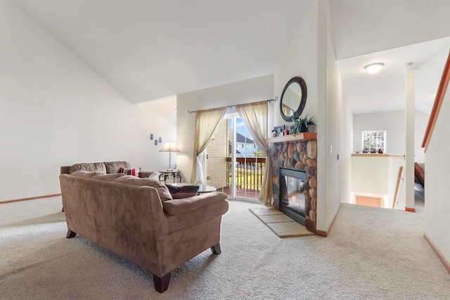 carpeted living room with a fireplace and high vaulted ceiling