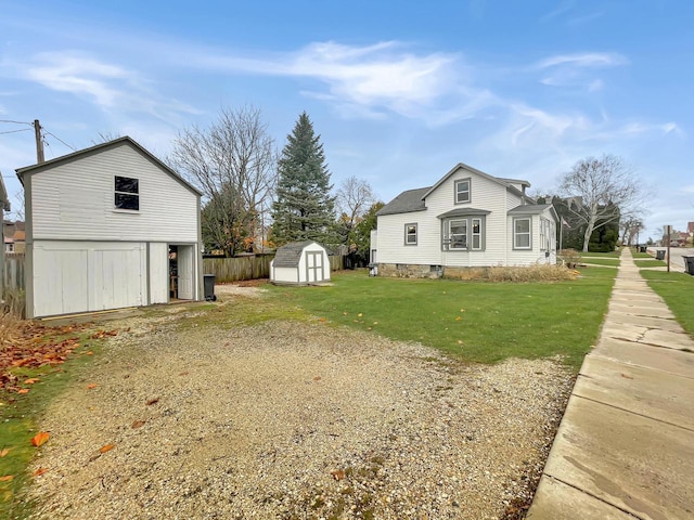 view of side of property featuring a yard and a storage unit