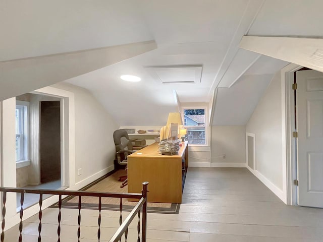 bonus room with hardwood / wood-style floors and vaulted ceiling