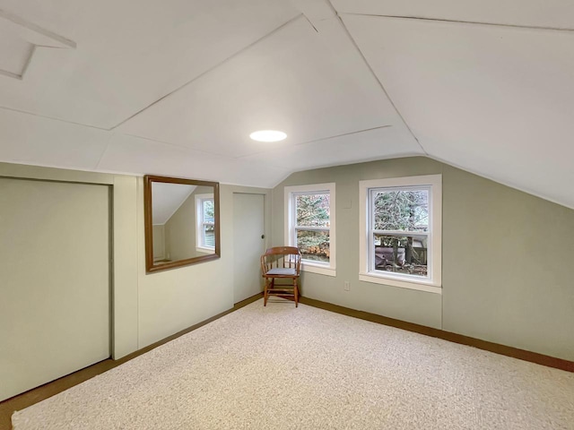 bonus room featuring carpet floors and lofted ceiling