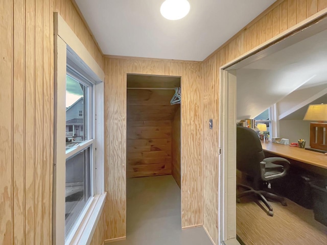 office with concrete flooring and wooden walls