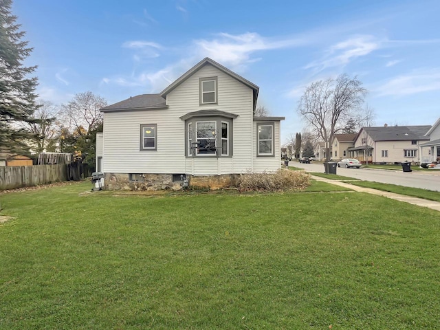 view of home's exterior with a yard