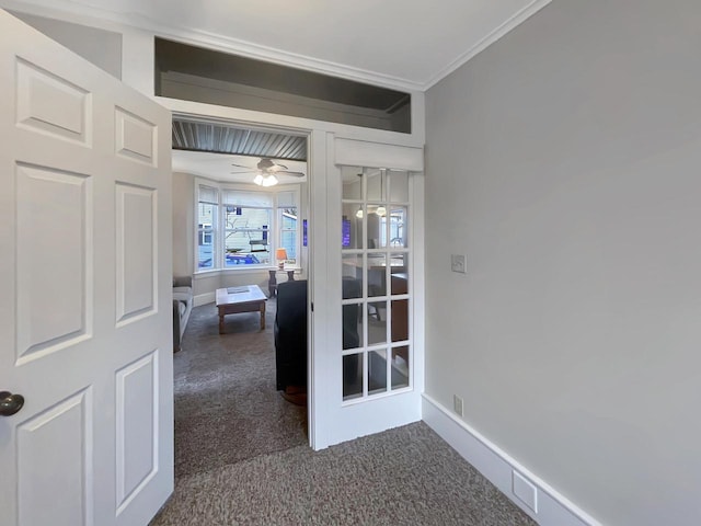 hall featuring dark carpet and ornamental molding