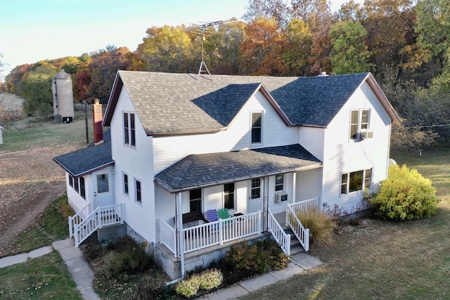 view of front of house featuring covered porch and cooling unit