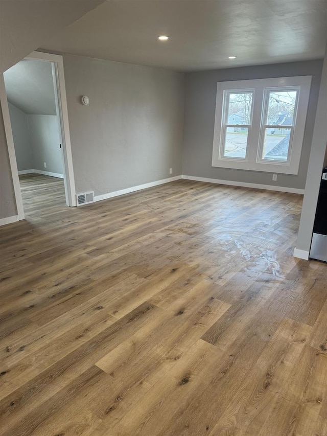 unfurnished room featuring recessed lighting, visible vents, baseboards, and wood finished floors