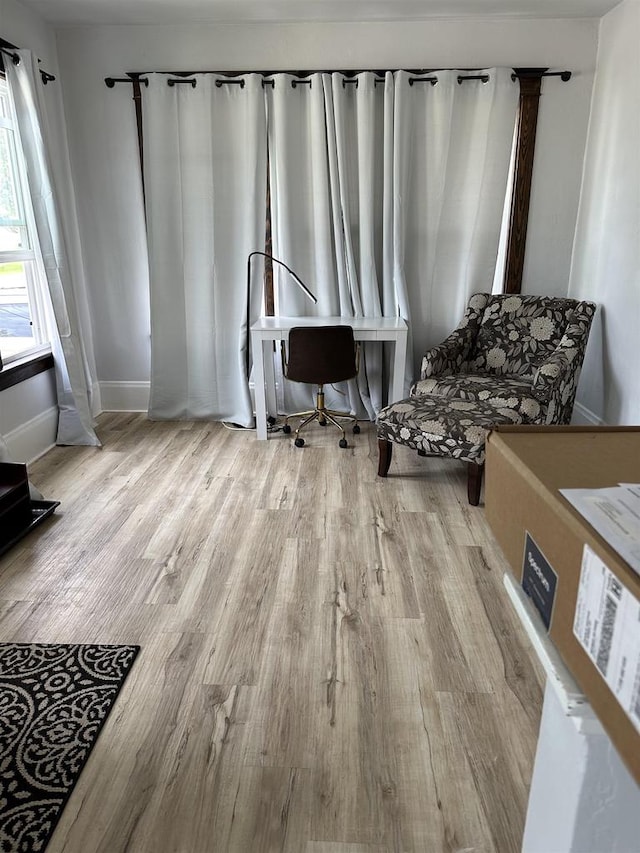 interior space with baseboards and wood finished floors