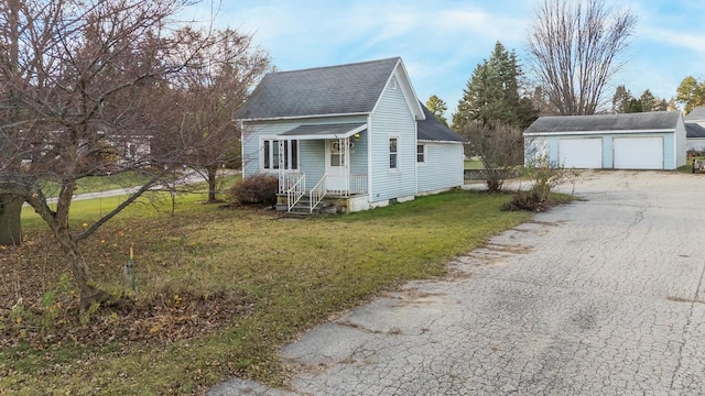 view of side of property featuring an outbuilding, a yard, and a garage