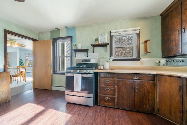 kitchen with gas stove, dark brown cabinetry, a healthy amount of sunlight, and dark wood-type flooring