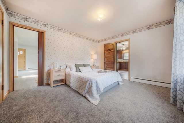 carpeted bedroom with ensuite bath and a baseboard heating unit