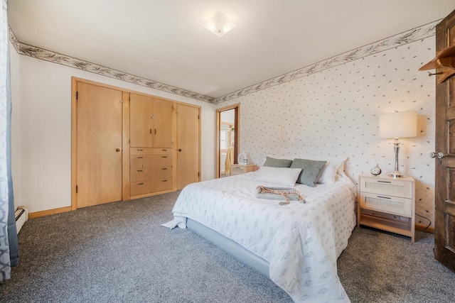 carpeted bedroom with a baseboard heating unit