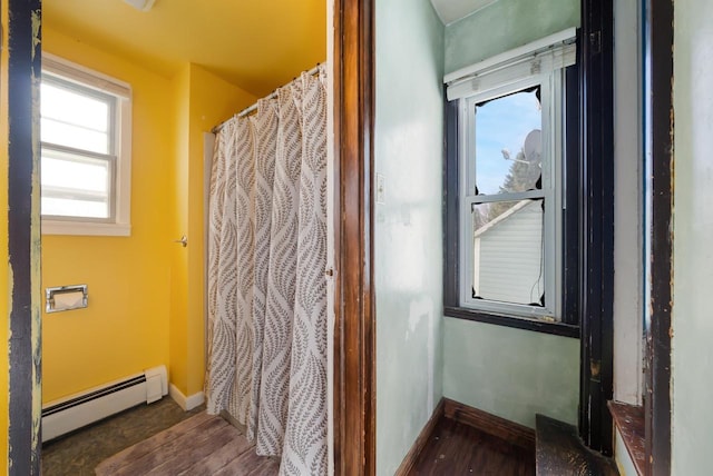 bathroom with a baseboard radiator and hardwood / wood-style flooring