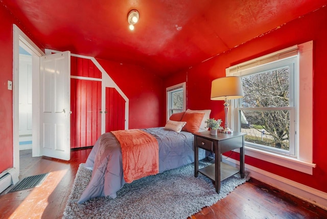 bedroom with hardwood / wood-style flooring and vaulted ceiling