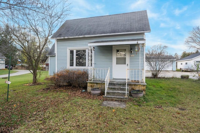 bungalow-style home featuring a front yard