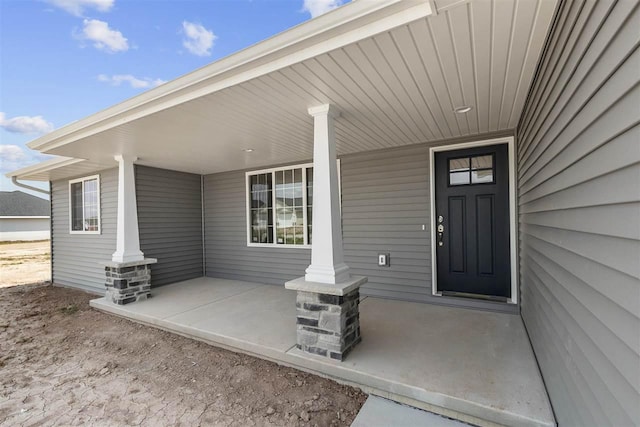 doorway to property featuring covered porch