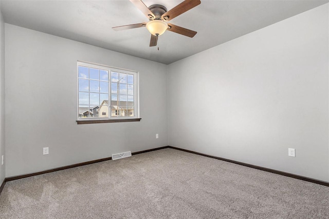 carpeted spare room featuring ceiling fan