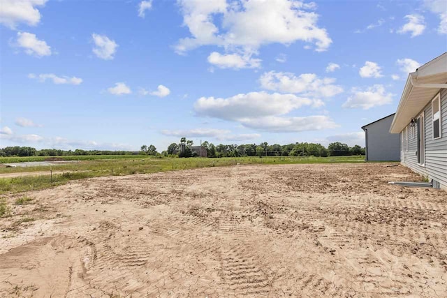 view of yard with a rural view