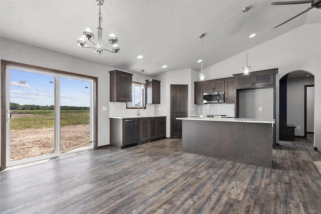 kitchen featuring dark wood-type flooring, stainless steel appliances, and vaulted ceiling