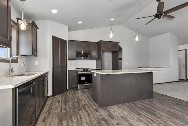 kitchen featuring dark wood-type flooring, sink, ceiling fan, a kitchen island, and stainless steel appliances