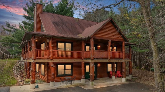 view of front facade featuring a patio and a deck