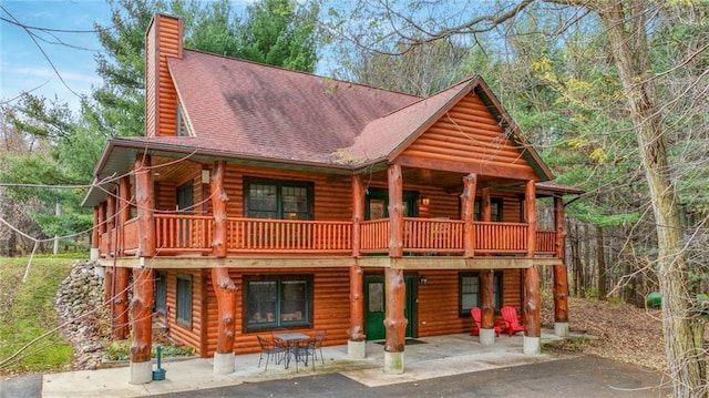 log-style house featuring a patio area