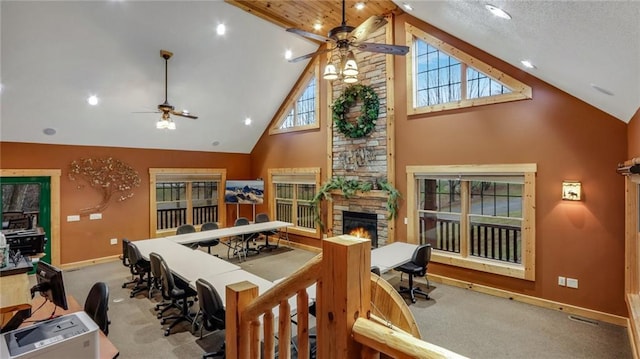 living room featuring ceiling fan, light colored carpet, a fireplace, and high vaulted ceiling