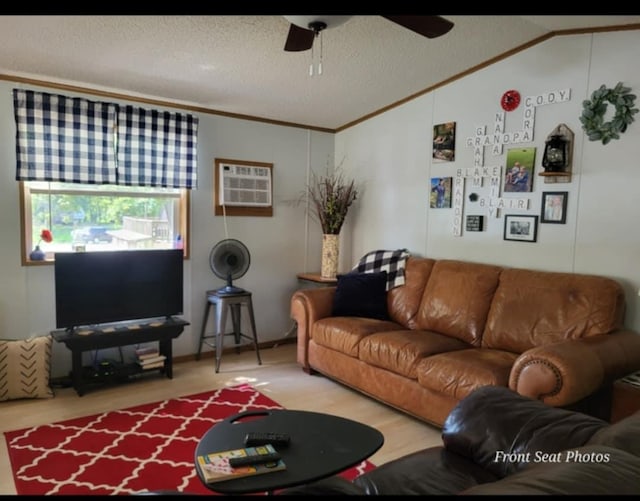 living room featuring a wall mounted AC, crown molding, wood-type flooring, vaulted ceiling, and a textured ceiling