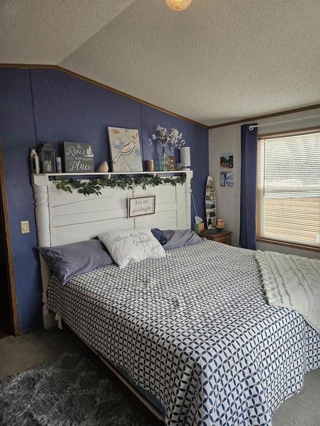 carpeted bedroom with a textured ceiling, crown molding, and vaulted ceiling