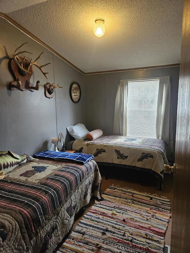 bedroom featuring crown molding, a textured ceiling, and vaulted ceiling