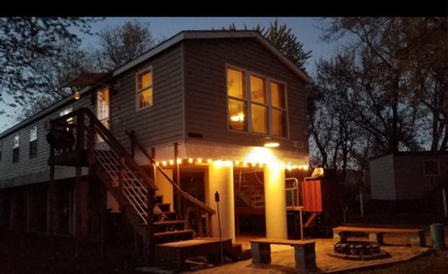 rear view of house with a fire pit and a patio area