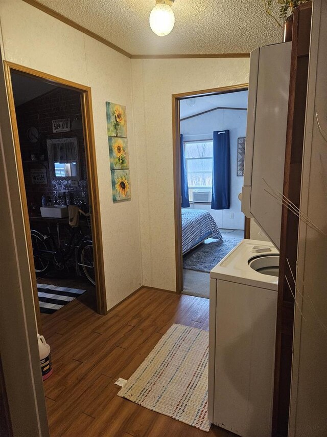 laundry area with cooling unit, wood-type flooring, and a textured ceiling