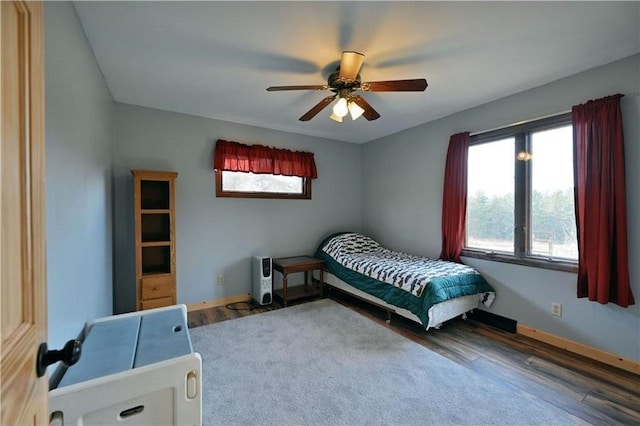 bedroom featuring hardwood / wood-style floors and ceiling fan