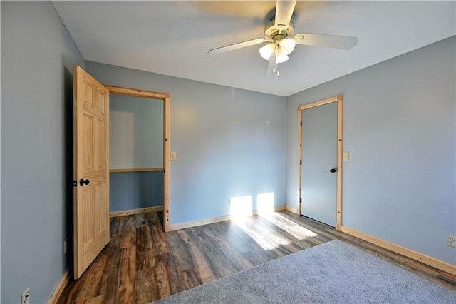 spare room with dark hardwood / wood-style floors and ceiling fan