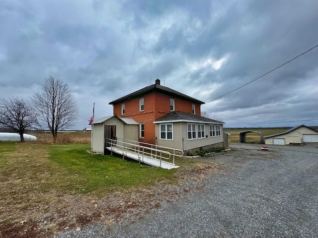 view of home's exterior with an outdoor structure