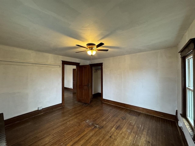 spare room with ceiling fan, plenty of natural light, and dark hardwood / wood-style floors