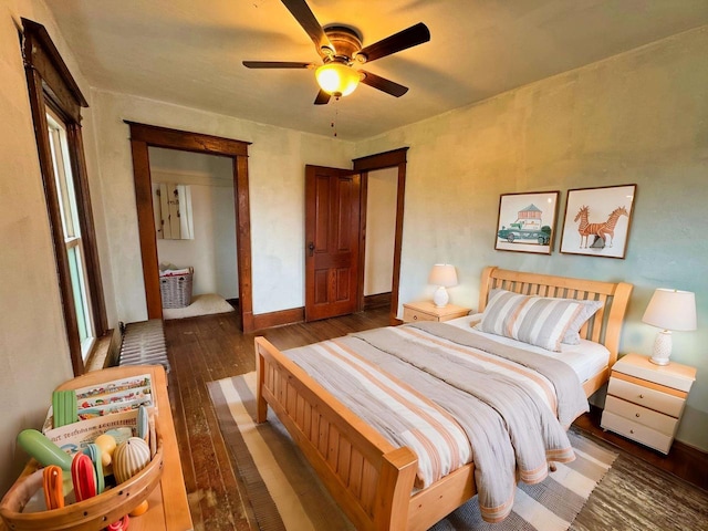 bedroom with dark hardwood / wood-style floors and ceiling fan