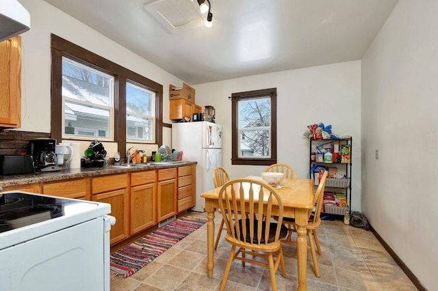 kitchen featuring a healthy amount of sunlight, white appliances, and sink