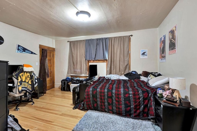 bedroom with hardwood / wood-style flooring