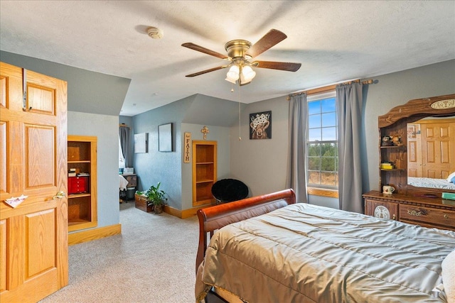 carpeted bedroom featuring a textured ceiling and ceiling fan