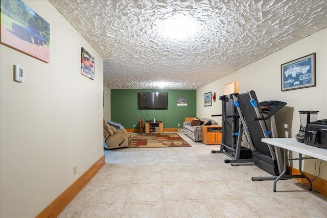 workout room with light tile patterned floors and a textured ceiling