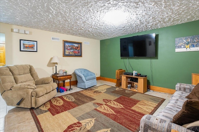 living room featuring light tile patterned floors and a textured ceiling