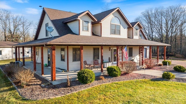 farmhouse inspired home with covered porch and a front yard