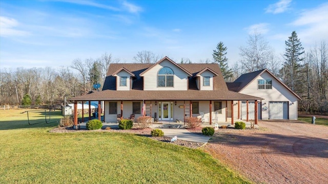 farmhouse with a front lawn, covered porch, and a garage