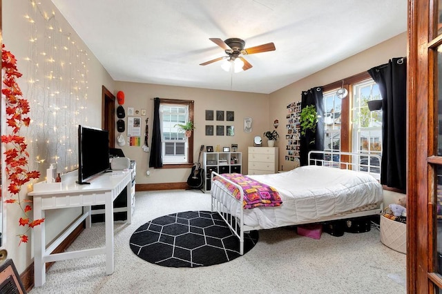 bedroom with ceiling fan and light colored carpet