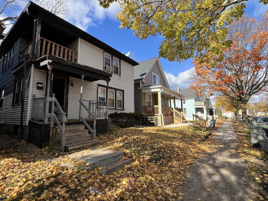 view of front of home with covered porch and a balcony