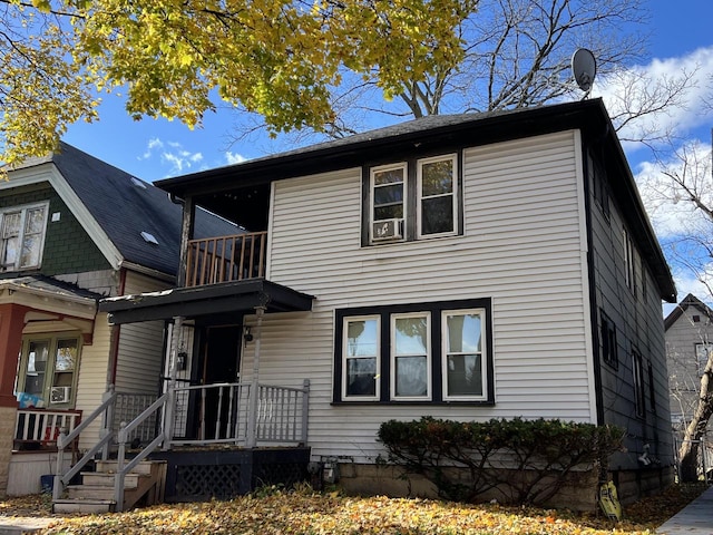 view of front of house featuring a balcony